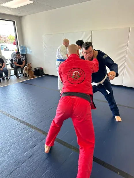 Students doing Jiu Jitsu with Coach Mark