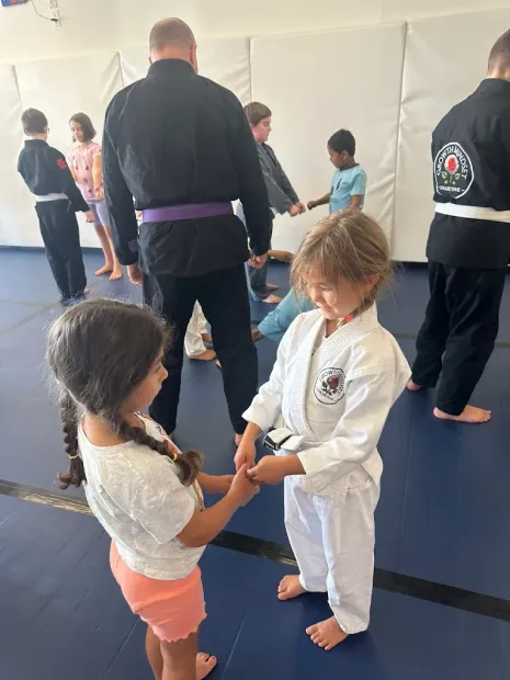 Young Children practicing breaking grips in a self defense class.