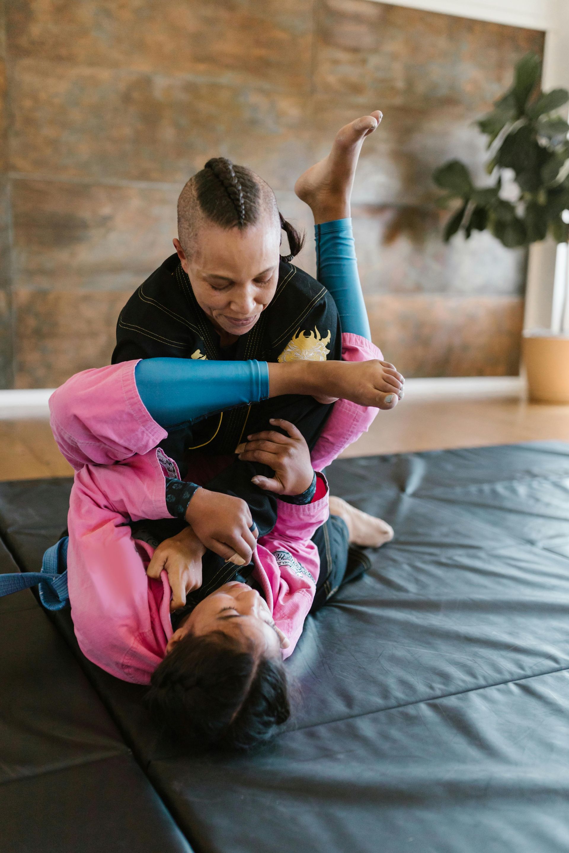 A student attempting to do an armbar from closed guard during the women's self defense class.