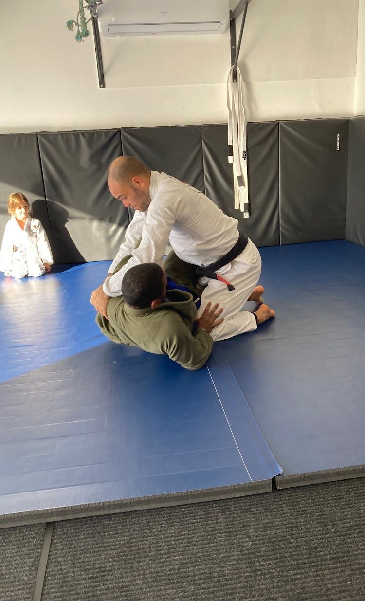 Coach Mark holding down a student in side control.