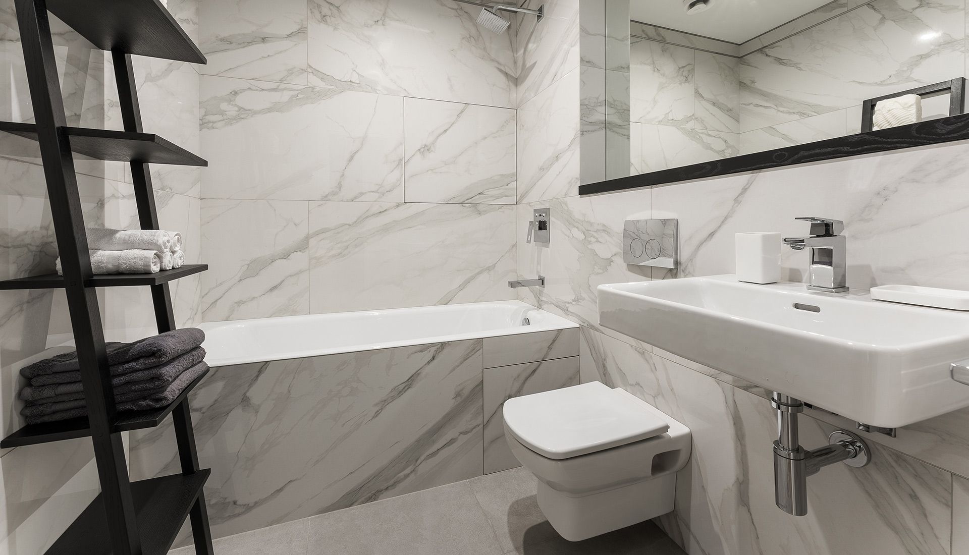 A bathroom with a sink , toilet , bathtub and mirror.