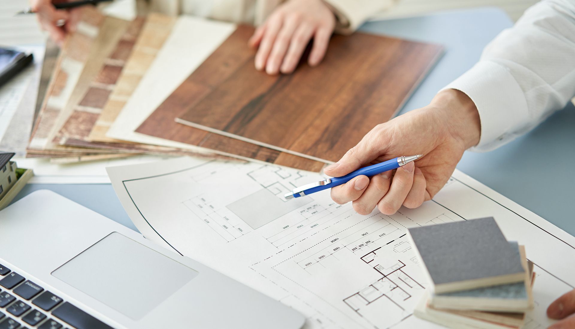 A person is holding a pen over a piece of paper.