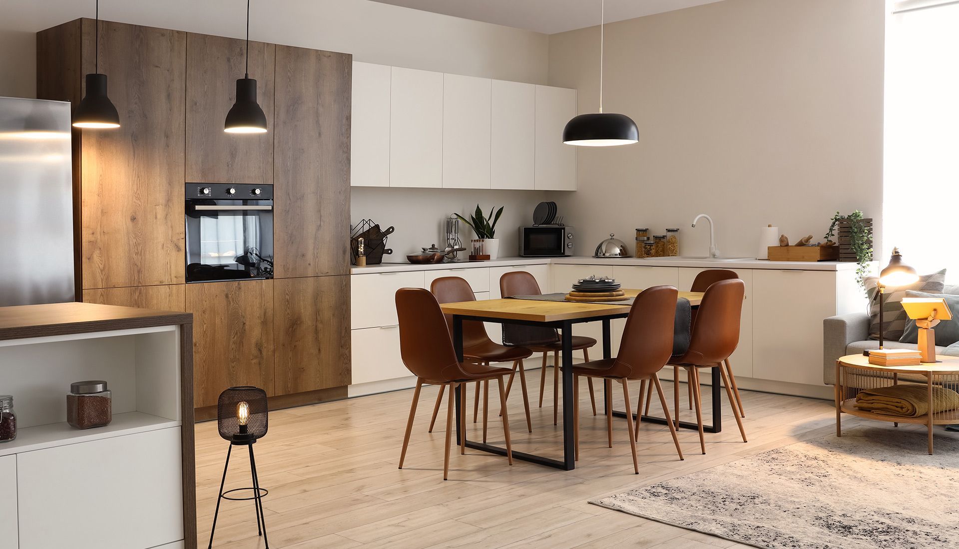 A kitchen with a dining table and chairs in it.