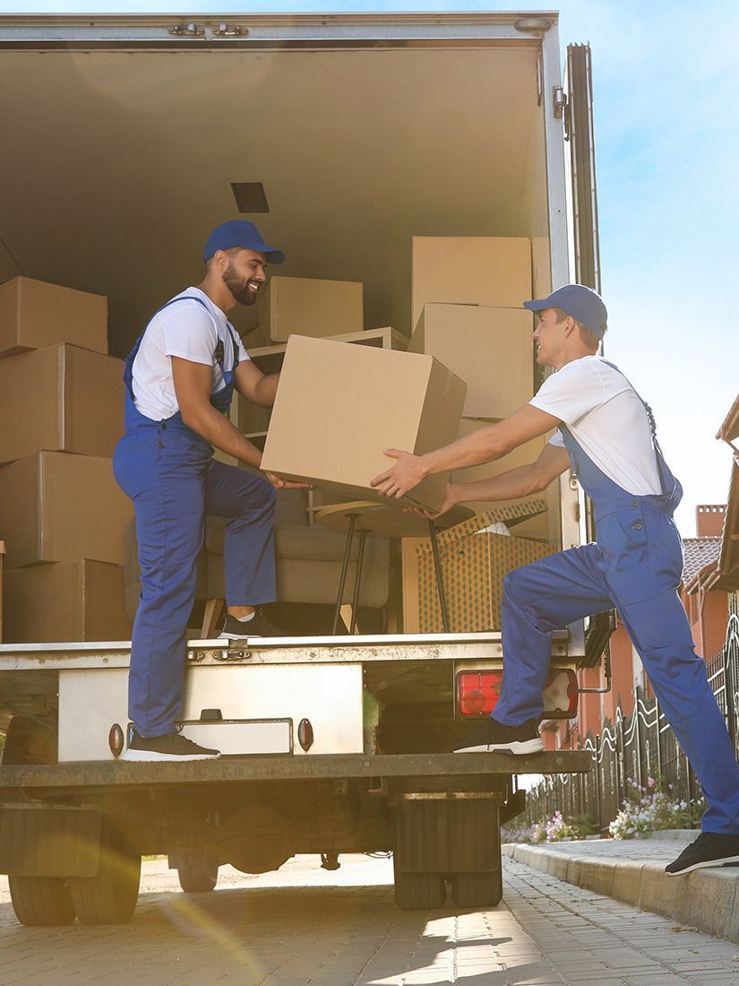 Two men are loading boxes into a truck.