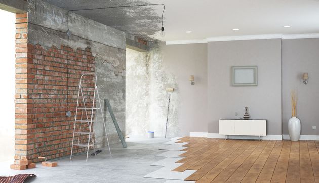 A before and after picture of a living room being remodeled.