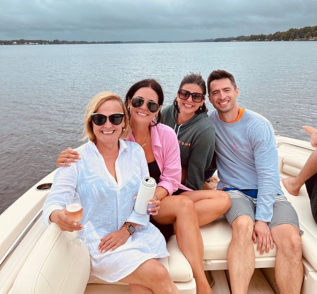 A group of people are sitting on a boat in the water.