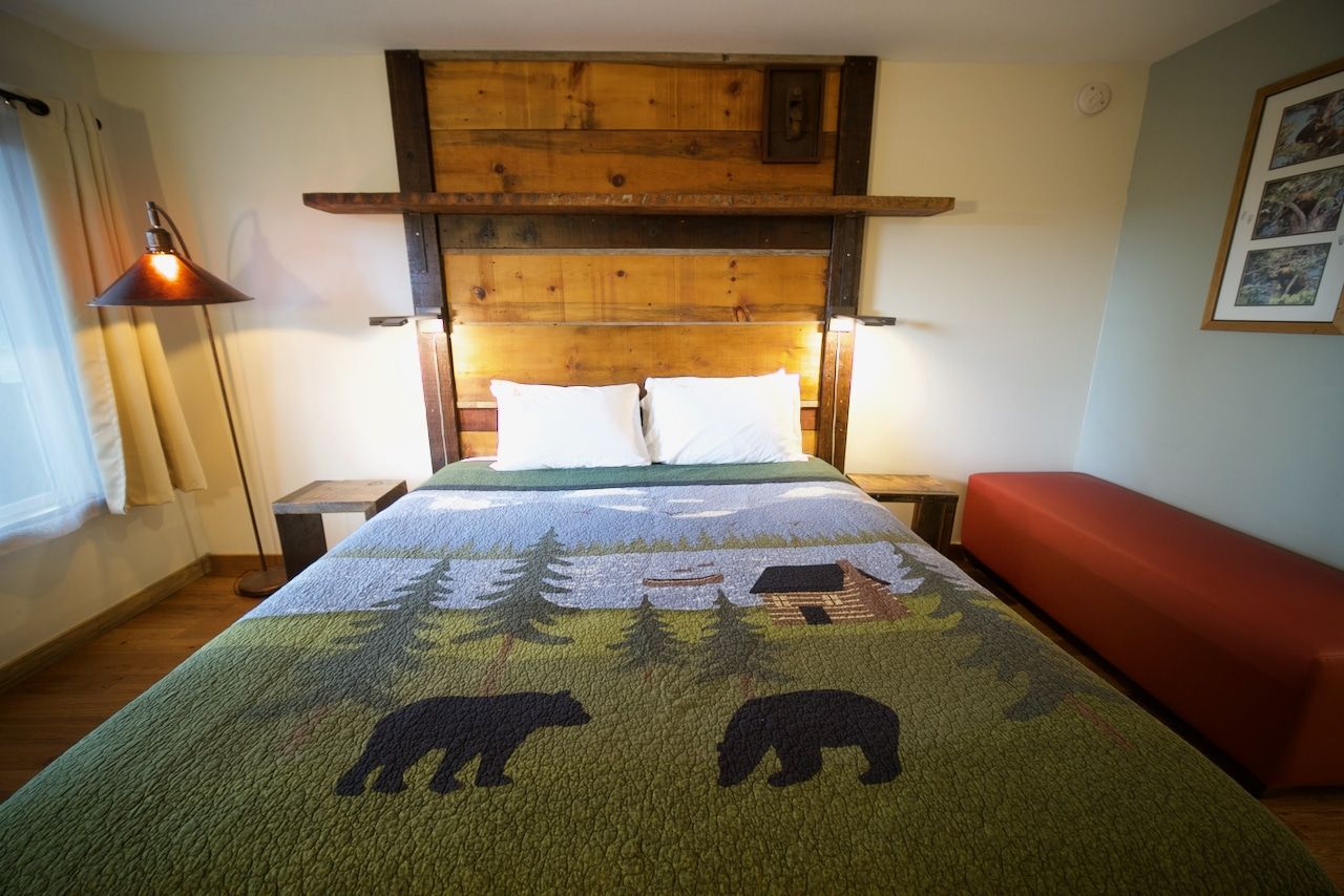 A bed with two bears on it in a bedroom