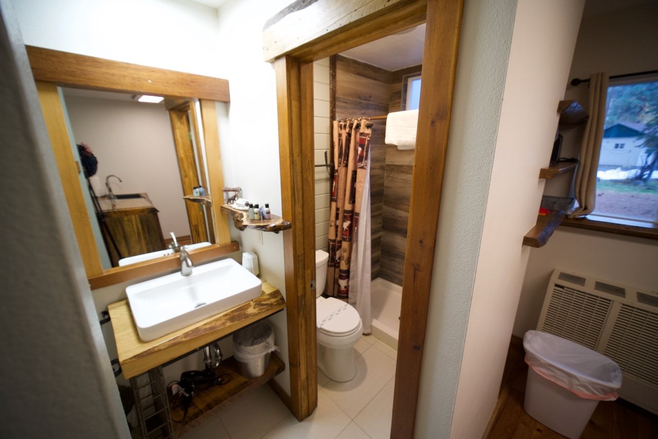 A bathroom with a sink , toilet and shower.