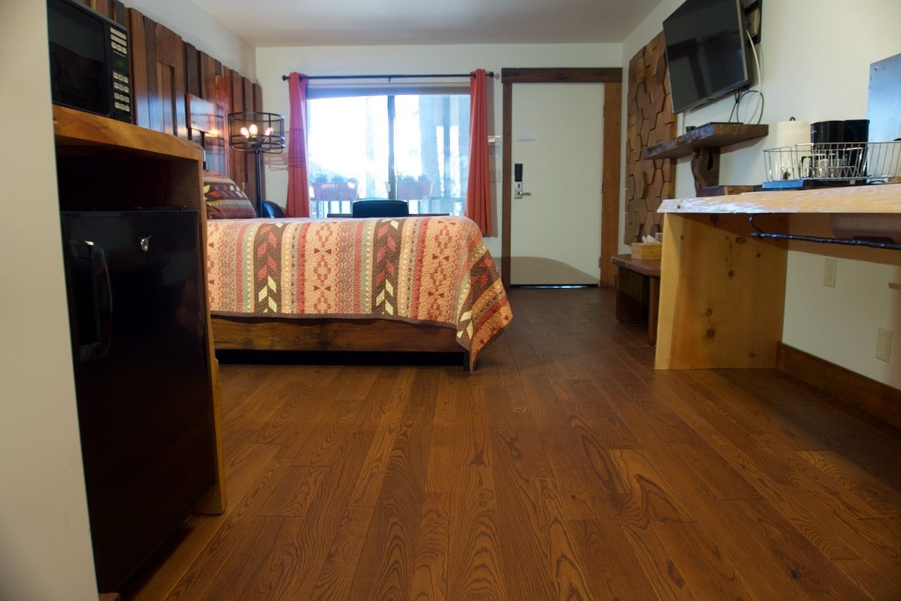 A hotel room with a bed and a desk