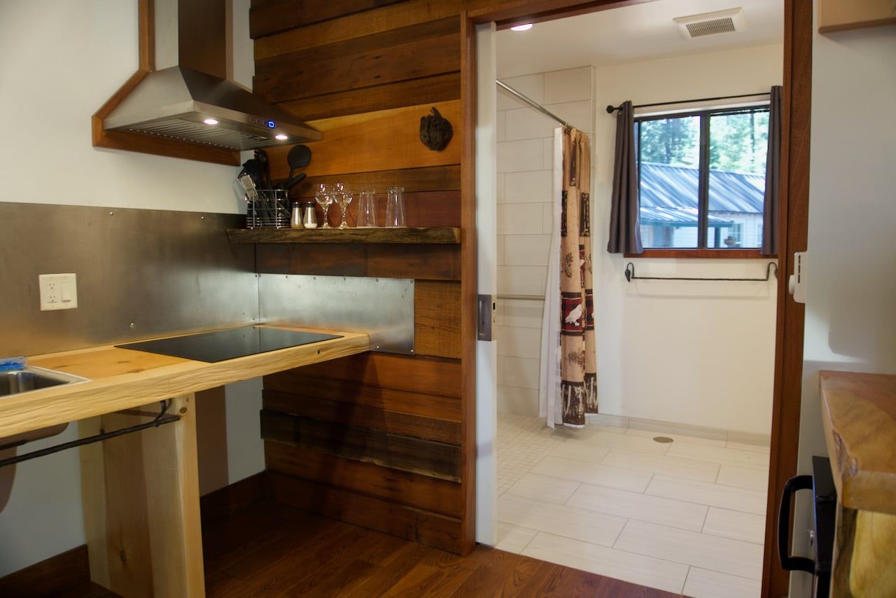 A kitchen with a sink and a stove top oven