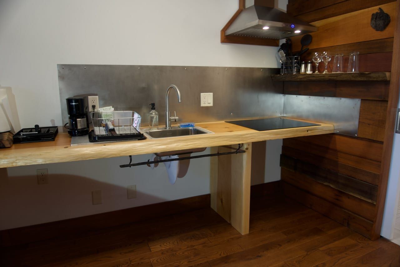 A kitchen with a sink and a stove top oven