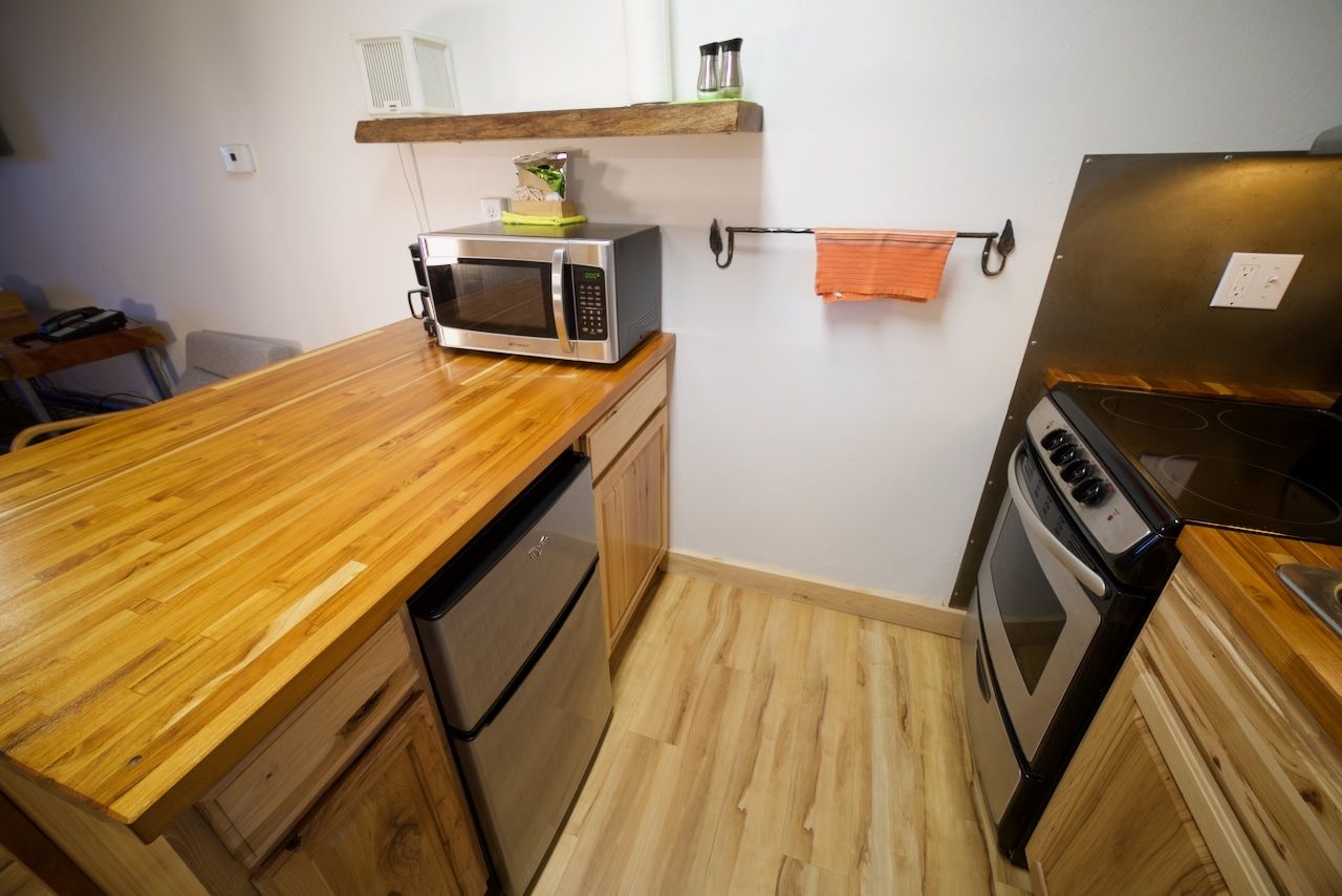 A kitchen with a refrigerator stove and microwave