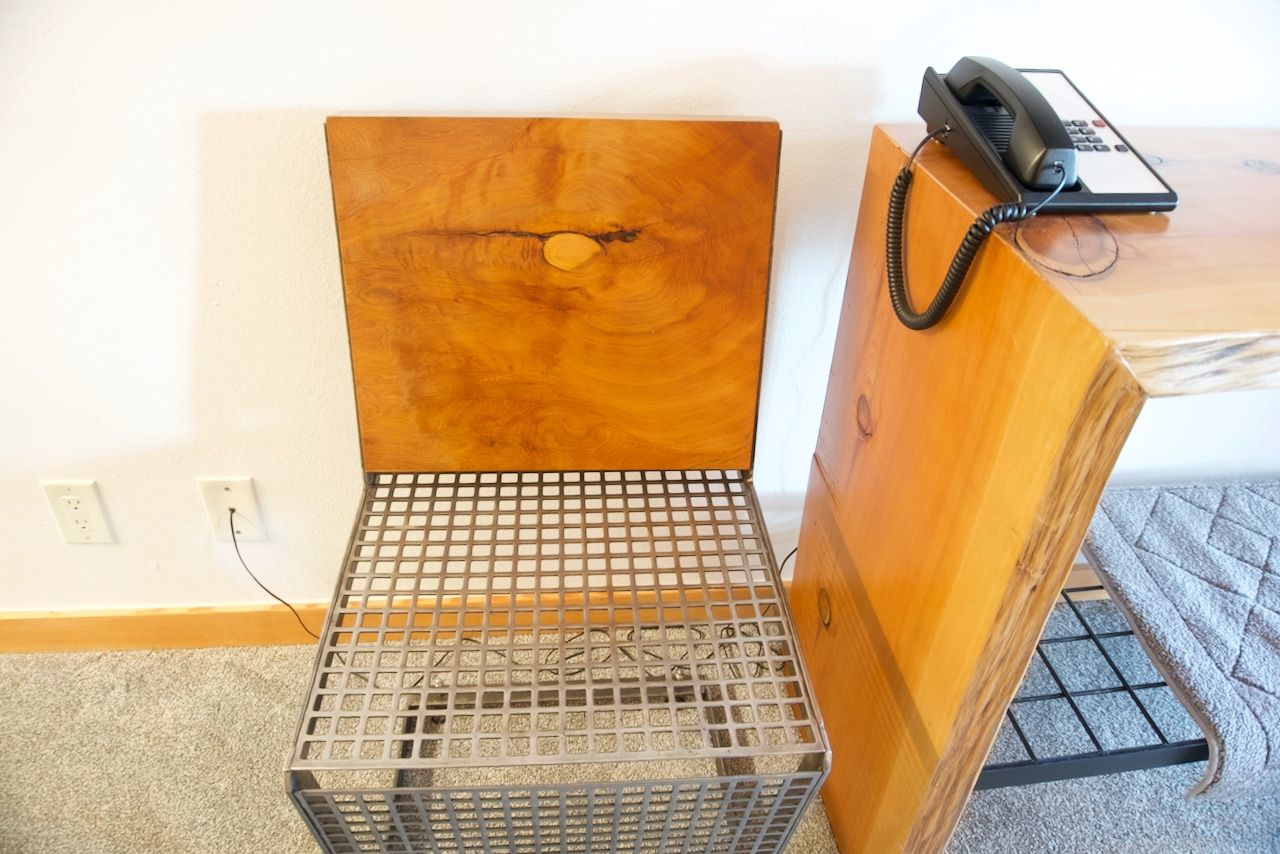 A phone is sitting on a desk next to a chair