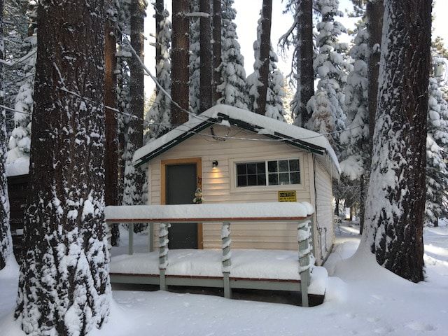 A small cabin in the middle of a snowy forest