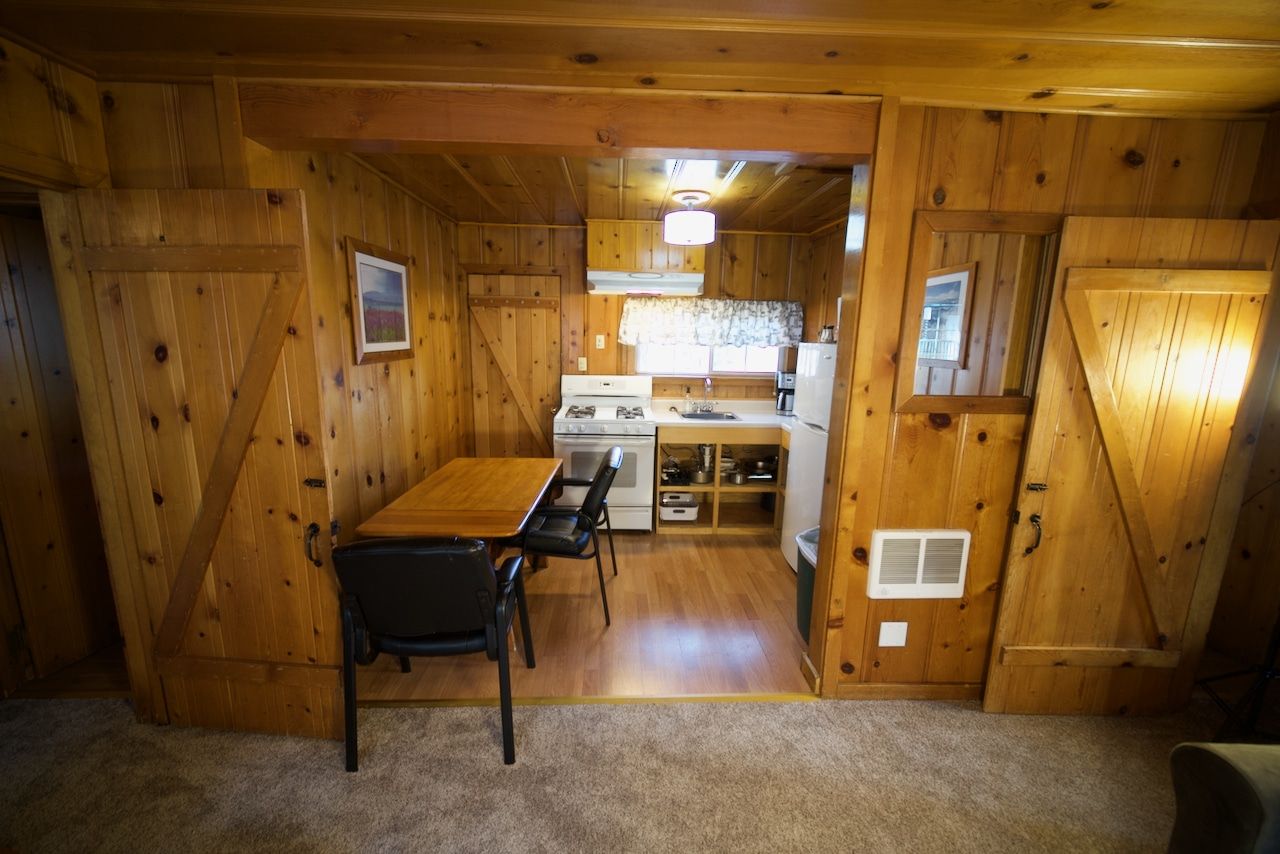 There is a table and chairs in the middle of the room.