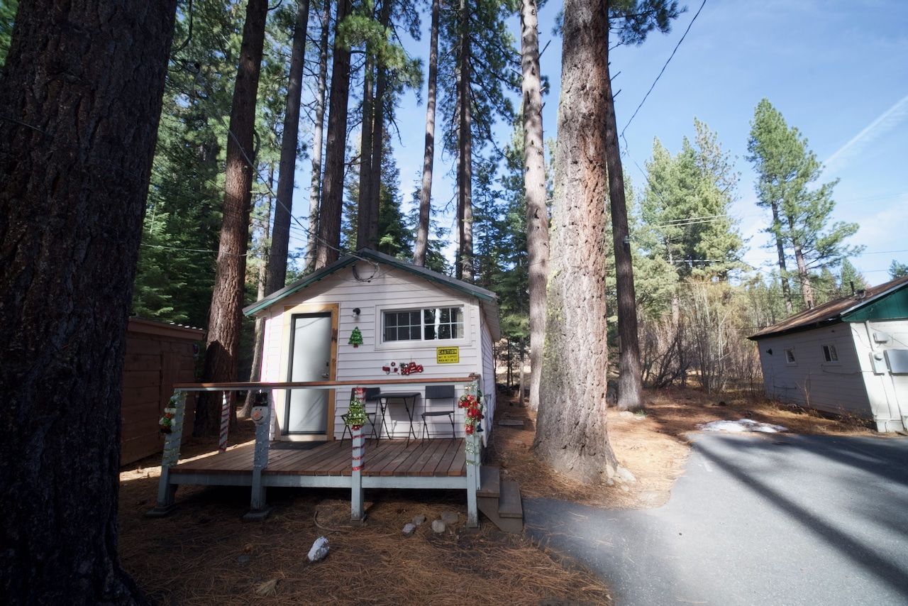 A small white house in the middle of a forest