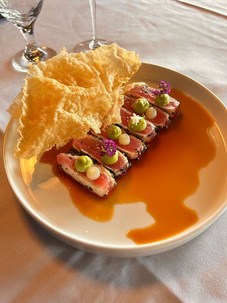 A white plate topped with a steak and shrimp