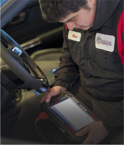 Mechanic uses diagnostic tool inside car to check system | Allegiance Automotive