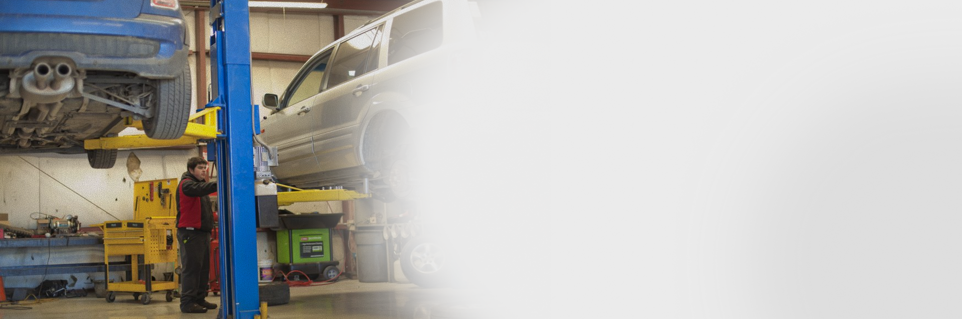 Mechanic working on a car lifted in an auto repair shop | Allegiance Automotive