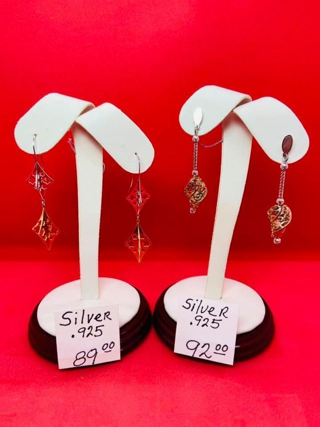 A pair of silver 925 earrings are on display