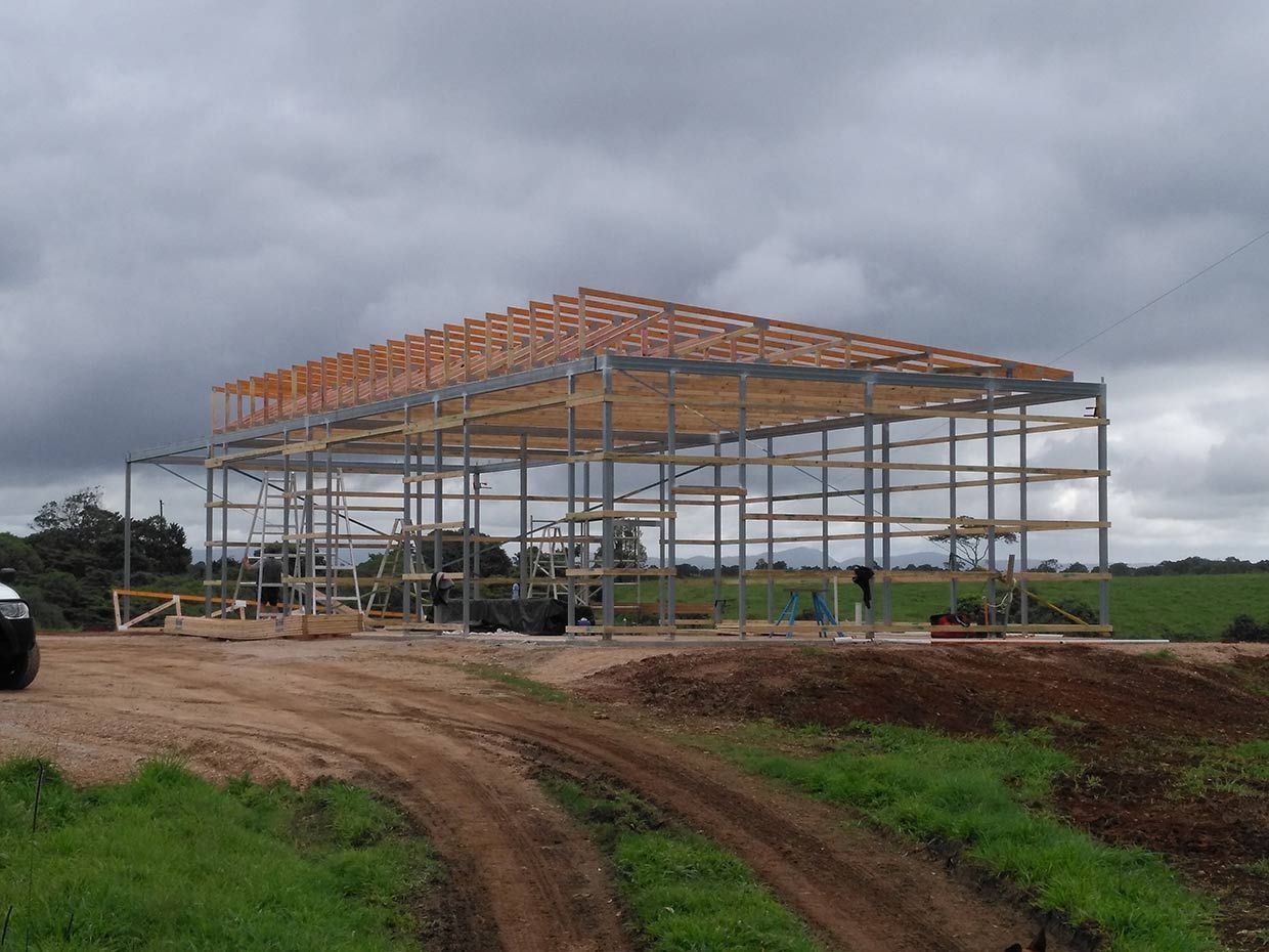 A Truck is Parked in Front of a Building Under Construction in a Field — Sven Margraf Constructions Pty Ltd In Atherton QLD