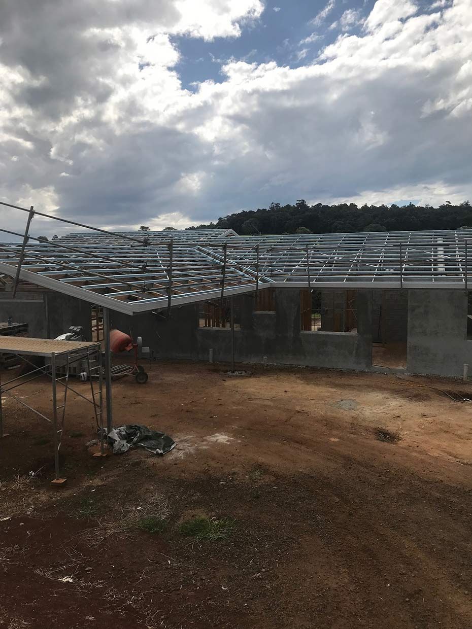 A Large Building is Being Built in the Middle of a Dirt Field — Sven Margraf Constructions Pty Ltd In Atherton QLD