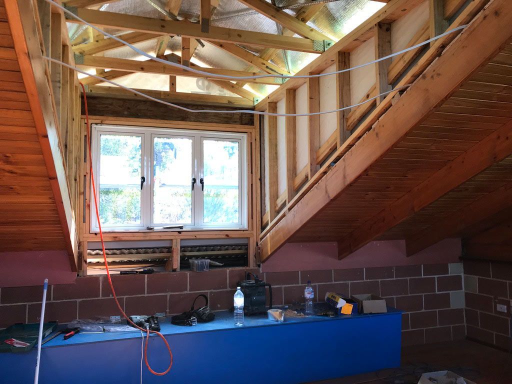 A Wooden Structure With a Window in the Middle of It — Sven Margraf Constructions Pty Ltd In Atherton QLD