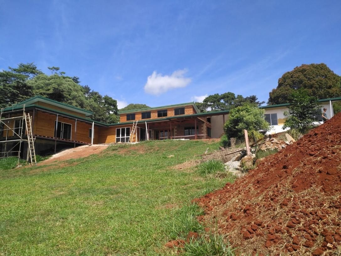 A House Is Being Built On A Hill Next To A Pile Of Dirt — Sven Margraf Constructions Pty Ltd In Atherton QLD