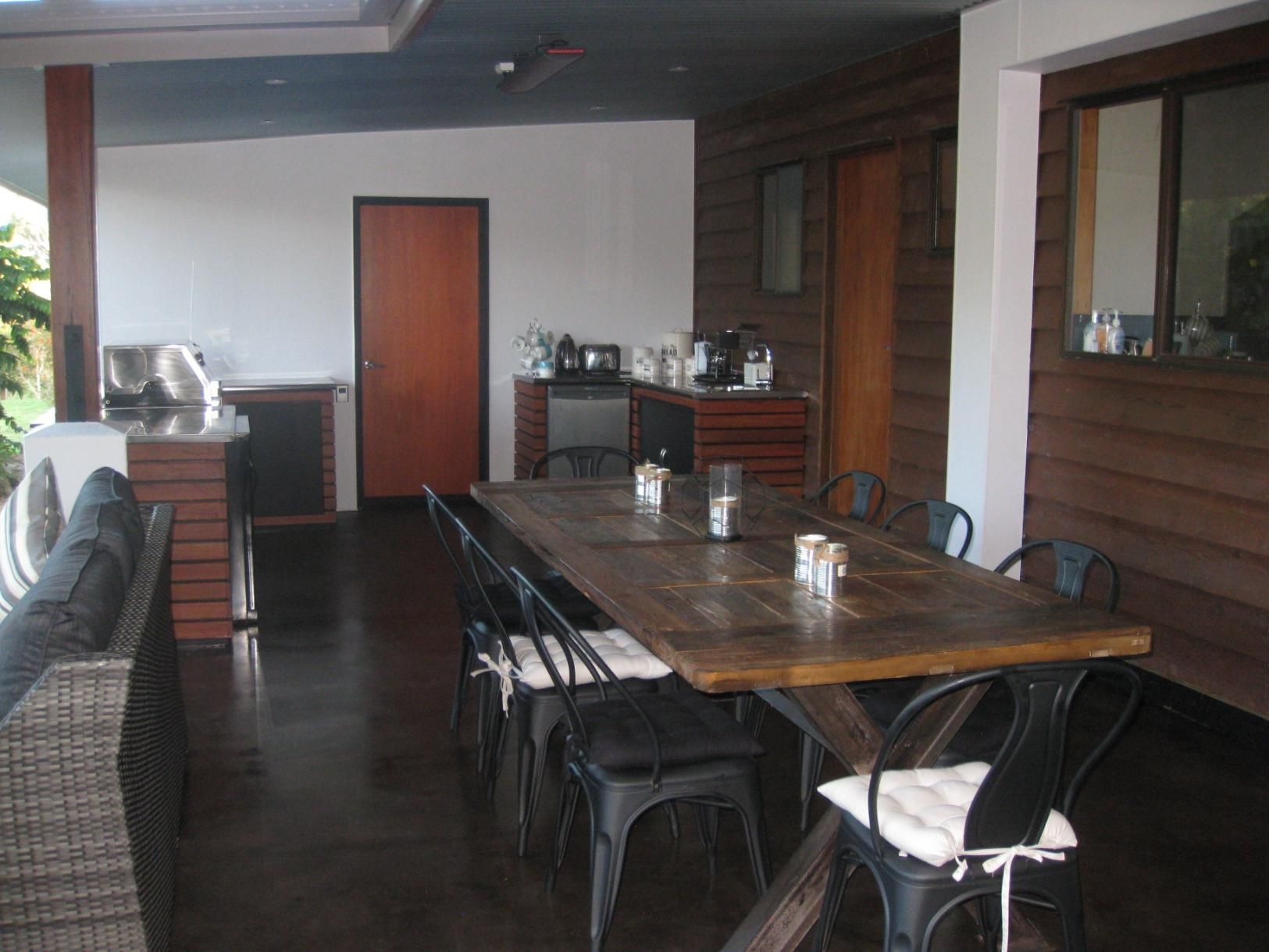 A Dining Room With A Long Wooden Table And Chairs — Sven Margraf Constructions Pty Ltd In Atherton QLD