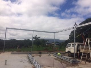 A White Truck Is Parked In Front Of A Building Under Construction — Sven Margraf Constructions Pty Ltd In Atherton QLD