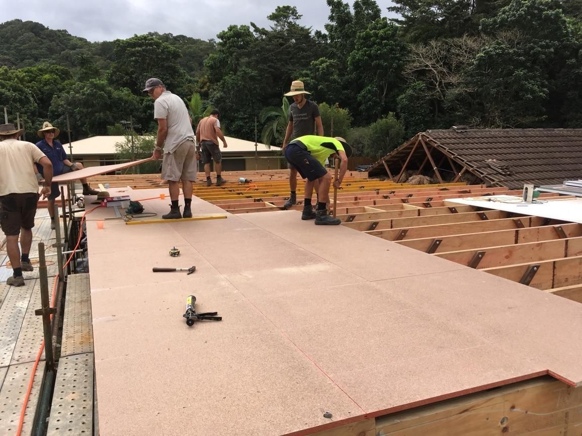A Group Of Construction Workers Are Working On A Roof — Sven Margraf Constructions Pty Ltd In Atherton QLD