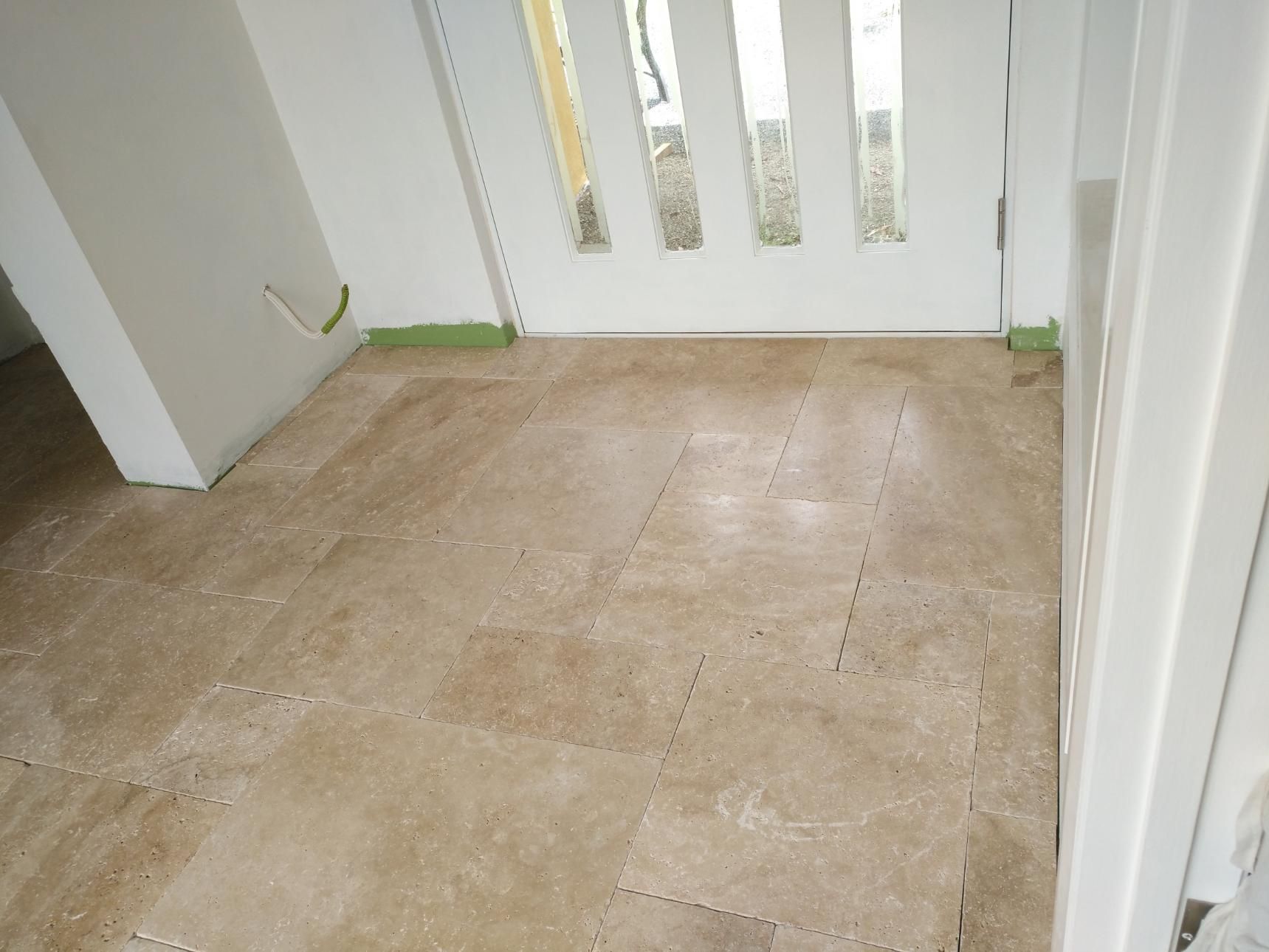 A Room With A Tiled Floor And A White Door — Sven Margraf Constructions Pty Ltd In Atherton QLD