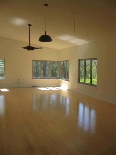 An Empty Room With A Ceiling Fan And Lots Of Windows — Sven Margraf Constructions Pty Ltd In Atherton QLD