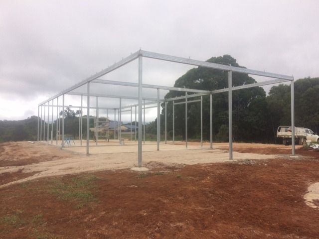 A Large Metal Structure Is Being Built In A Dirt Field — Sven Margraf Constructions Pty Ltd In Atherton QLD