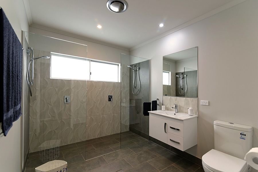 A Bathroom With A Toilet, Sink And Walk In Shower — Sven Margraf Constructions Pty Ltd In Atherton QLD