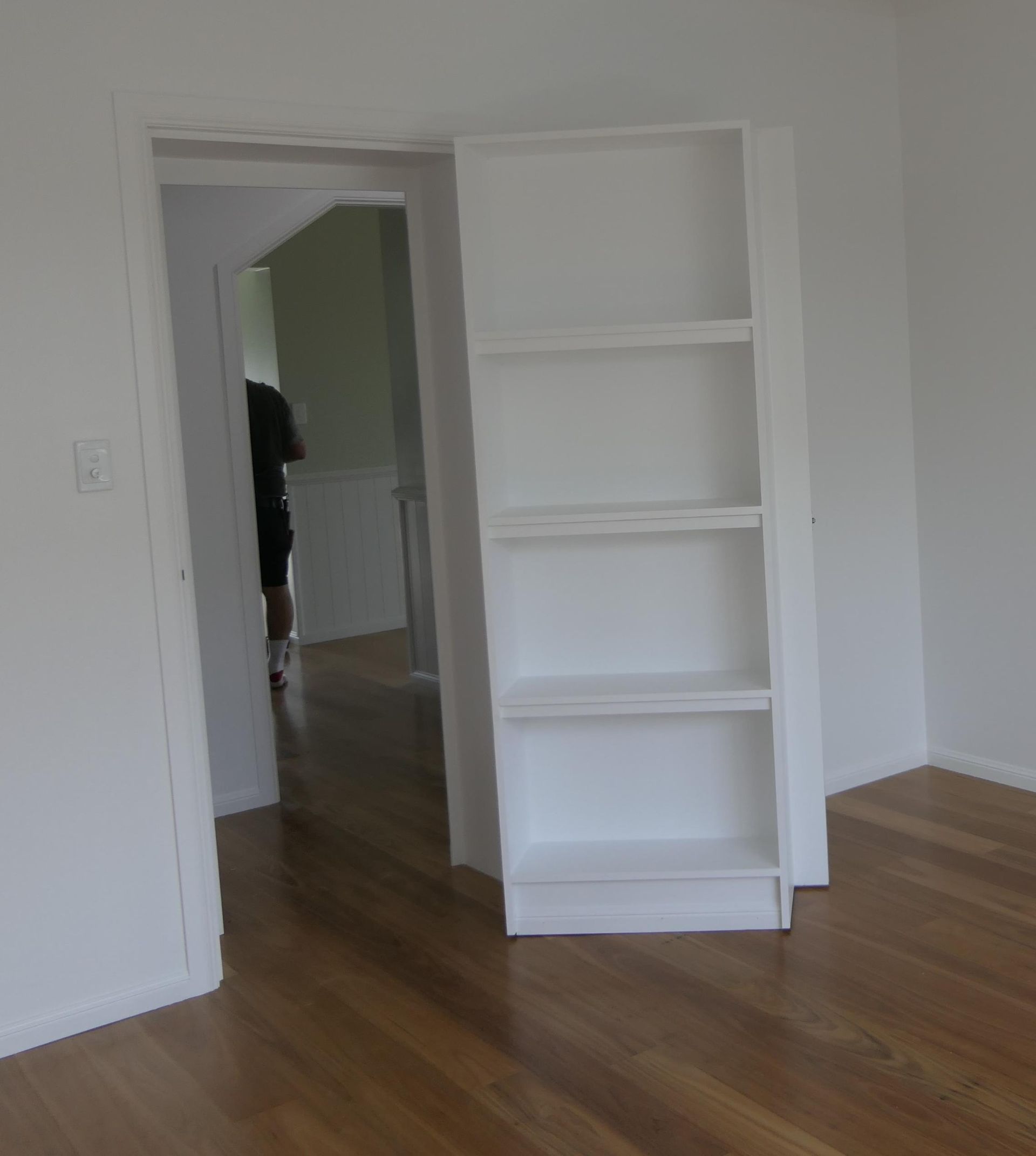 An Empty Room With A White Bookshelf In The Middle — Sven Margraf Constructions Pty Ltd In Atherton QLD