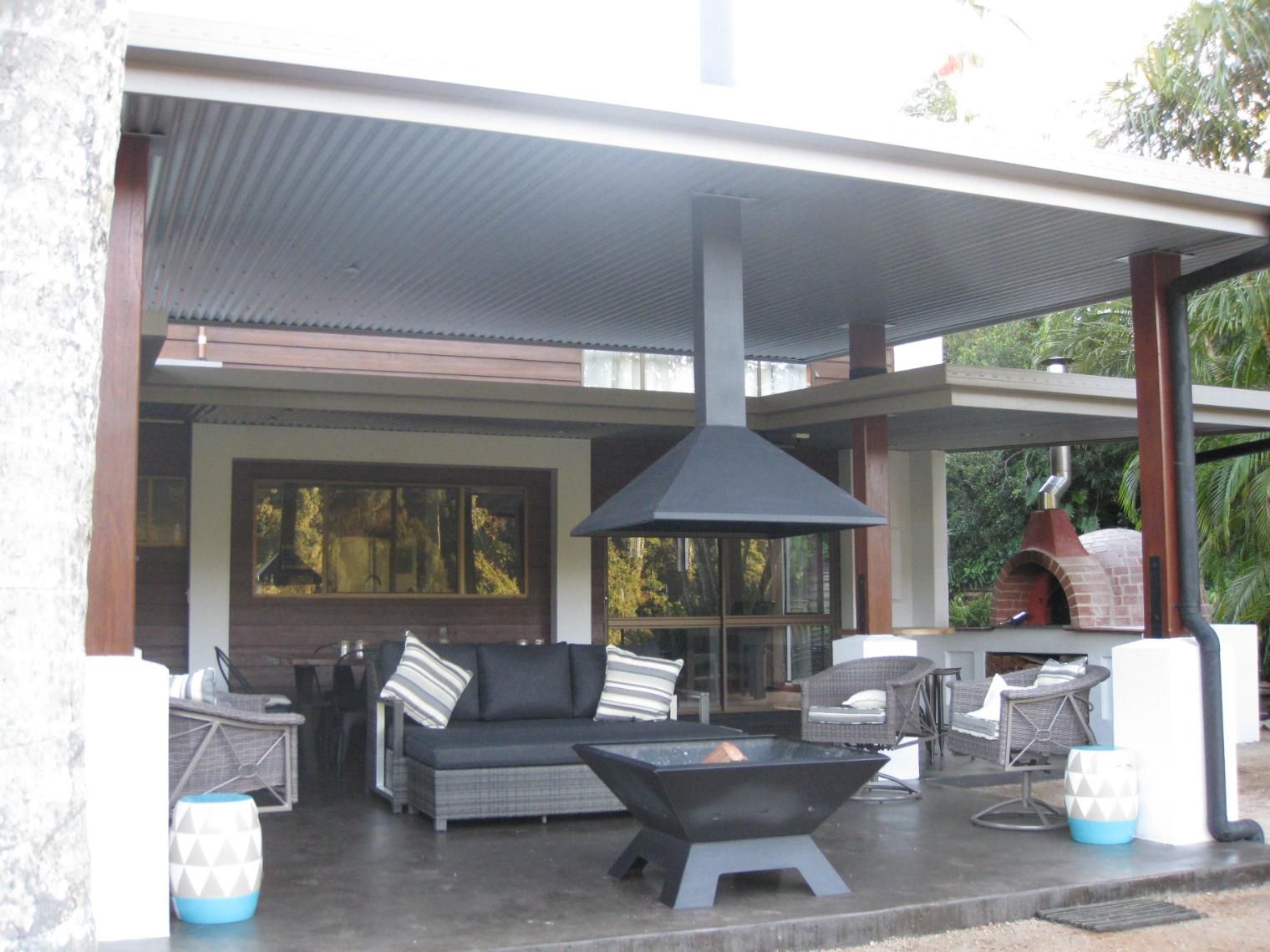 A Living Room With A Couch And A Fire Pit — Sven Margraf Constructions Pty Ltd In Atherton QLD