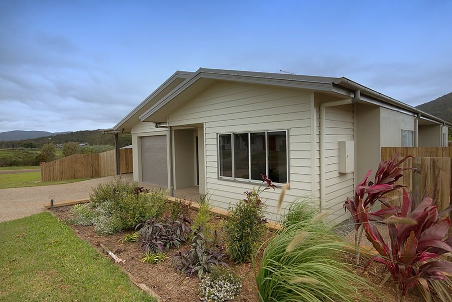 A Small White House With A Garage And A Fence In Front Of It — Sven Margraf Constructions Pty Ltd In Atherton QLD
