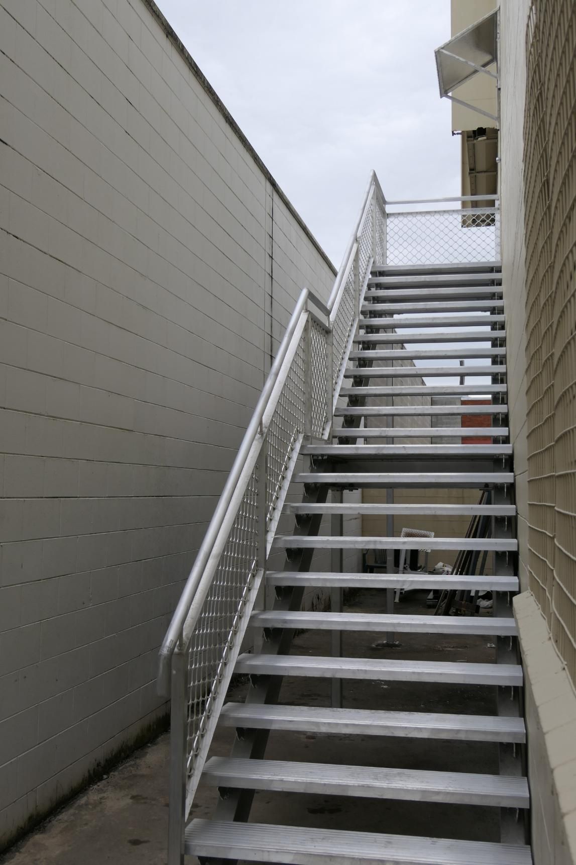 A Set Of Stairs Leading Up To A Building With A Metal Railing — Sven Margraf Constructions Pty Ltd In Atherton QLD