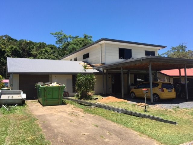 A Yellow Car Is Parked Under A Canopy In Front Of A House — Sven Margraf Constructions Pty Ltd In Atherton QLD