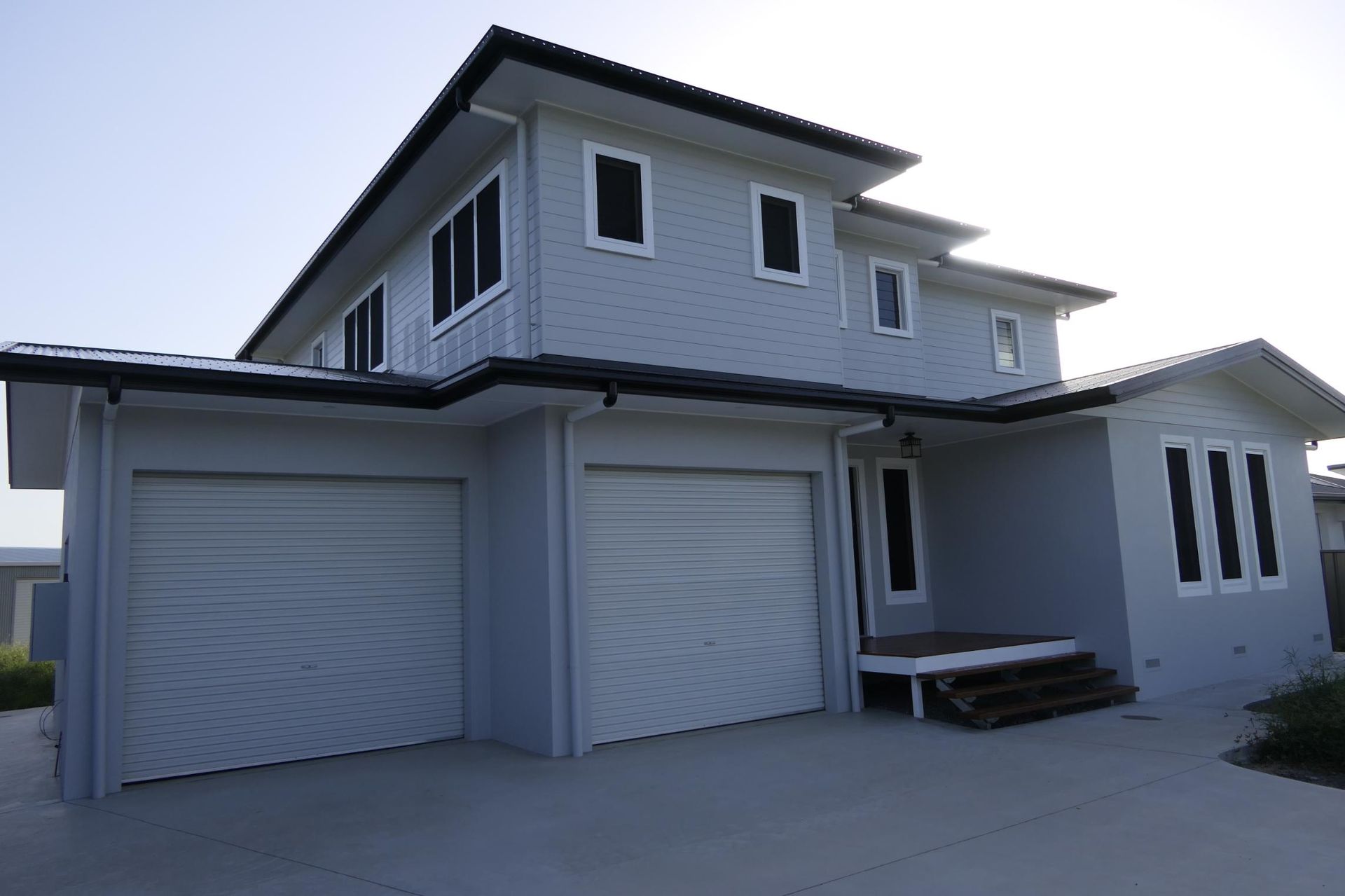 A White House With Two Garage Doors And Three Windows — Sven Margraf Constructions Pty Ltd In Atherton QLD