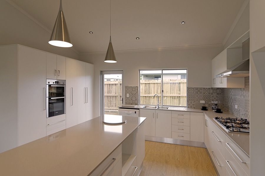 A Kitchen With White Cabinets And Stainless Steel Appliances — Sven Margraf Constructions Pty Ltd In Atherton QLD