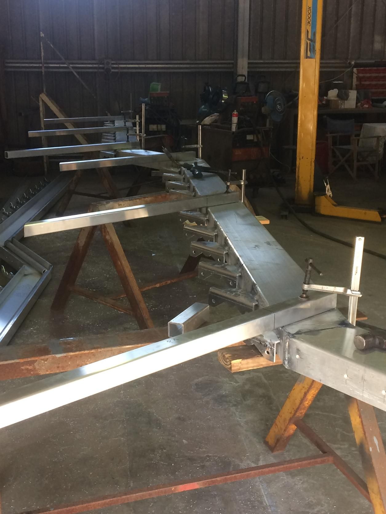 A Metal Structure Is Sitting On A Wooden Table In A Workshop — Sven Margraf Constructions Pty Ltd In Atherton QLD
