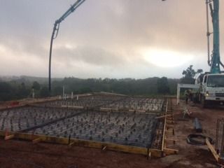 A Concrete Pump Is Being Used To Pour Concrete On A Construction Site — Sven Margraf Constructions Pty Ltd In Atherton QLD