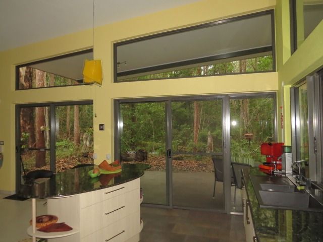 A Kitchen With A Lot Of Windows And A Red Coffee Maker — Sven Margraf Constructions Pty Ltd In Atherton QLD