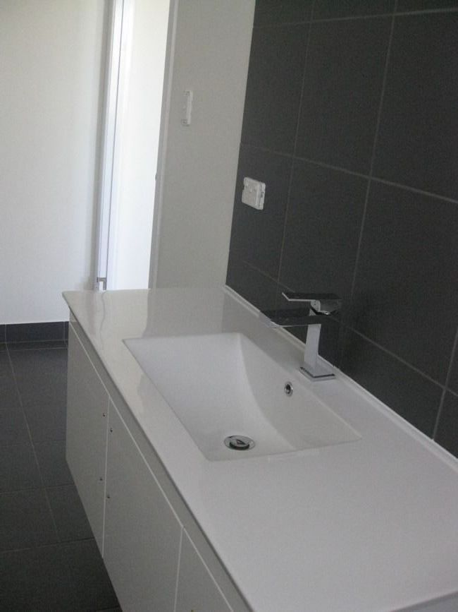 A Bathroom With A Sink And A Window — Sven Margraf Constructions Pty Ltd In Atherton QLD