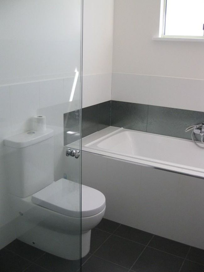 A Bathroom With A Toilet And A Shower Stall — Sven Margraf Constructions Pty Ltd In Atherton QLD