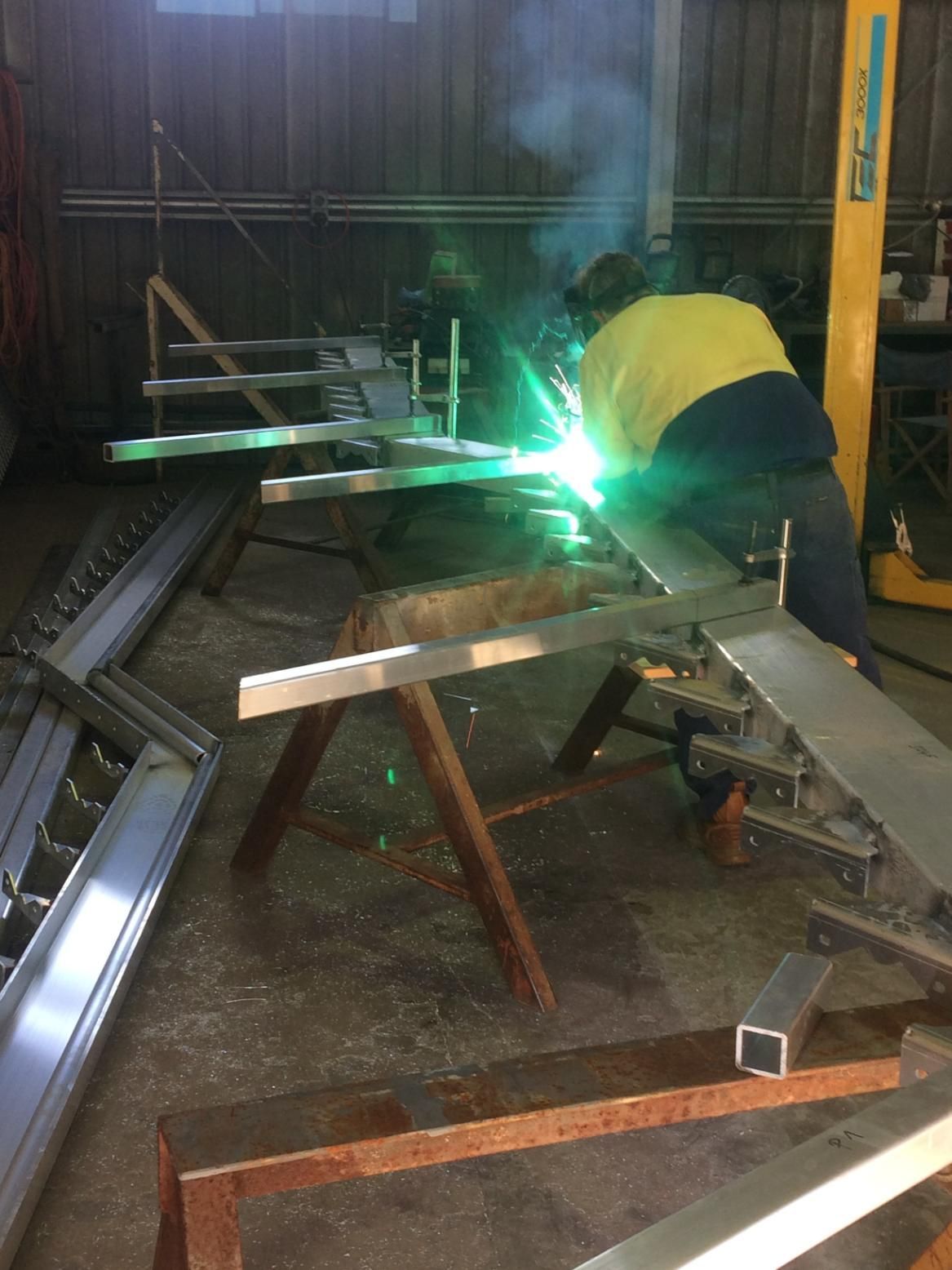 A Man Is Welding A Piece Of Metal In A Workshop — Sven Margraf Constructions Pty Ltd In Atherton QLD