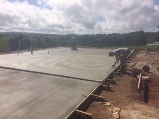 A Man Is Working On A Concrete Floor In A Field — Sven Margraf Constructions Pty Ltd In Atherton QLD
