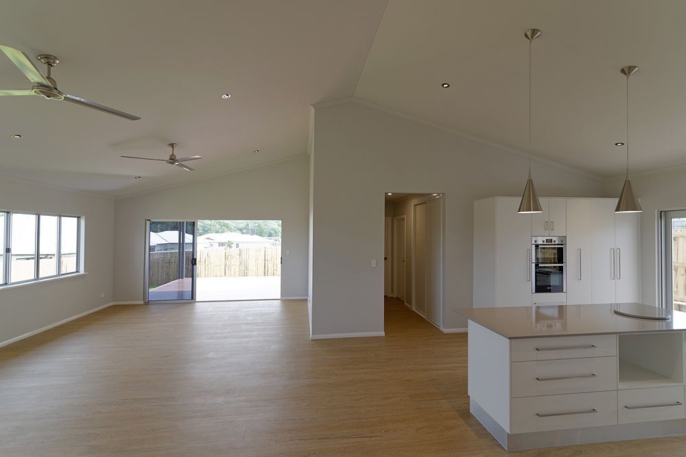 A Large Empty Room With a Kitchen and a Ceiling Fan — Sven Margraf Constructions Pty Ltd In Atherton QLD